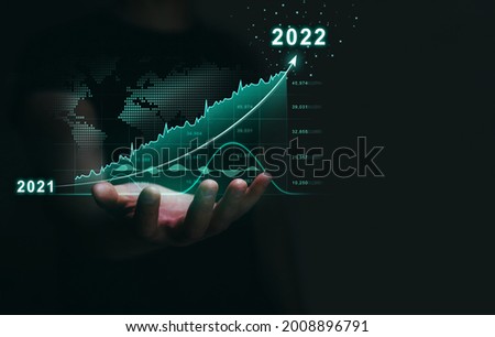 Increasing revenues and business in the new year 2022. 
 Businessman holding growth  arrow graph corporate future growth year 2021 to 2022. 
Development to success.
