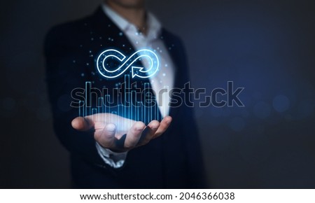 Businessman holding in hand growth graph  and Circular economy symbol. Futuristic Circular economy concept. 