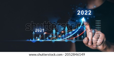 Businessman draws  increase arrow graph corporate future growth year 2021 to 2022.   Planning,opportunity, challenge and business strategy. New Goals, Plans and Visions for Next Year 2022. 商業照片 © 