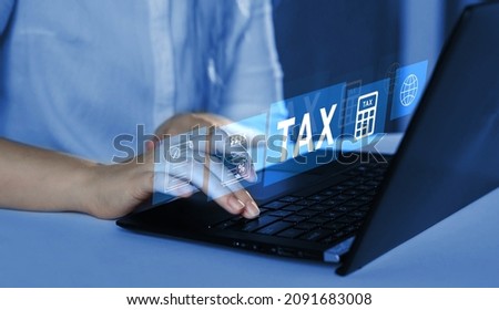 Business person using the laptop to fill in the income  tax online return form for payment. Financial research,government taxes and calculation tax return concept. Tax and Vat time.