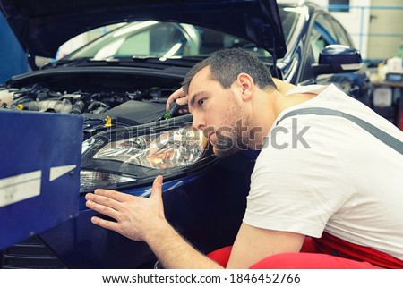 adjusting the headlights on the car by mechanics in a garage Photo stock © 