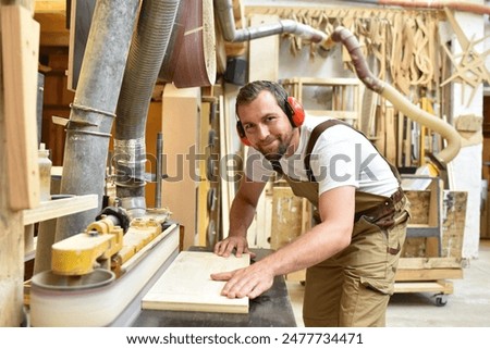 Similar – Image, Stock Photo Builder at work with wooden roof construction.