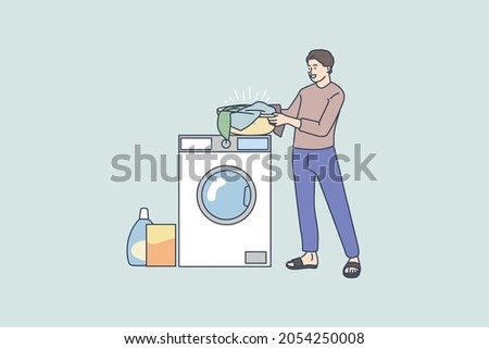 Smiling young man near washing machine do laundry wash clothes with soap powder detergent. Happy male perform housework at laundromat. Domestic chores concept. Flat vector illustration. 