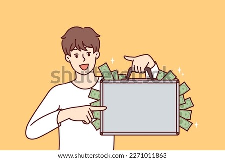 Happy man with suitcase full of money showing off big profits from own business or cash won at casino. Rich guy who made lot of money after selling real estate or received unexpected inheritance