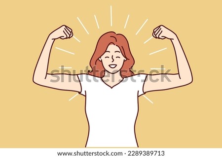Woman shows biceps and smiles standing in strongman pose to demonstrate self-confidence and readiness for new achievements. Girl boasts biceps after going to fitness room and training with trainer 