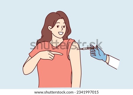 Woman gets injection in shoulder getting vaccinated and points finger at syringe in doctor hand. Preventive protection against influenza or pandemic and vaccinated to avoid infection with virus
