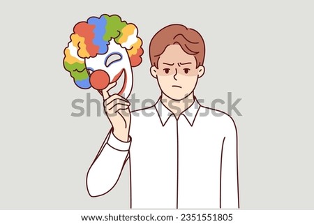 Angry man takes off mask happy clown for concept of duplicity and hypocrisy person pretending to be jester. Metaphor bipolar disorder in guy demonstrating hypocrisy when communicating or working