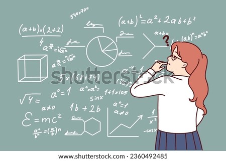 Little girl stands near school chalk board with formulas and tries to solve difficult problem. Child prodigy student in elementary school thought about solving theorem from higher mathematics