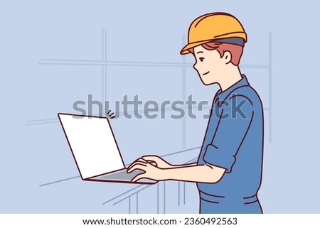 Man with laptop works as engineer in factory and performs setup of production machines, dressed in uniform and hardhat. System administrator of factory or industrial enterprise uses computer