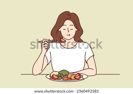 Woman eats appetizing fresh vegetable salad and closes eyes, enjoying delicious and healthy diet. Girl has lunch or dinner with vegetables, according to advice of nutritionist, recommended new diet