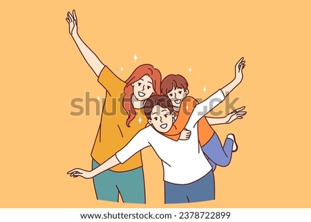 Happy family of mom, dad and child put arms to sides, pretending to be airplanes, and posing for group portrait. Cheerful family having fun and smiling looking at camera to share good mood