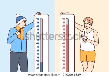 Man stands near thermometers showing different temperatures and feels heat or cold in different countries. Giant thermometers near happy guys for magazine with meteorological forecasts