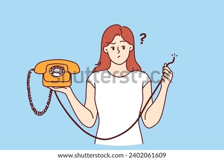 Embarrassed woman is holding retro telephone with torn wire, and is wondering how to restore telephony to call friends. Girl was left without communication due to broken telephone and needs repairman