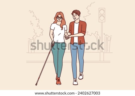 Man helps blind woman walk through park, enjoying city accessible environment for people with disabilities. Blind girl in sunglasses uses special cane to search for obstacles on way