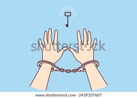 Man in handcuffs reaches for key, wanting freedom and independence, metaphor for solution to problem found. Prisoner sees chance for freedom after unjust court decision that ruined person life