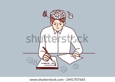 Man writer writes story for own book, sits at table with crumpled papers instead of brain. Young guy is writer inspired to create own literary novel or series script with sharp plot twists