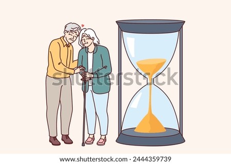 Elderly couple senses fading away and approach of death, standing near giant hourglass symbolizing life. Loving man with woman demonstrate devotion and love despite old age or end of life