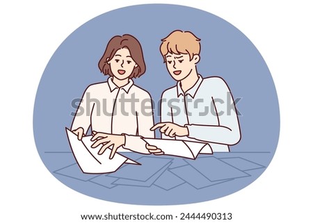 Man and woman are standing near table sorting through business documents in search right letter from partners or tax notice. Guy and girl studying contracts from large number pages