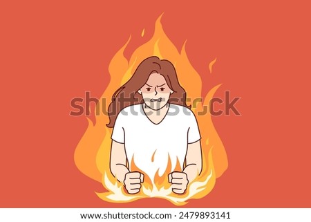 Nervous woman experiencing aggression due to psychological problems, standing in middle of burning flame. Girl aggression and disappointment are caused by bad character and defensiveness.