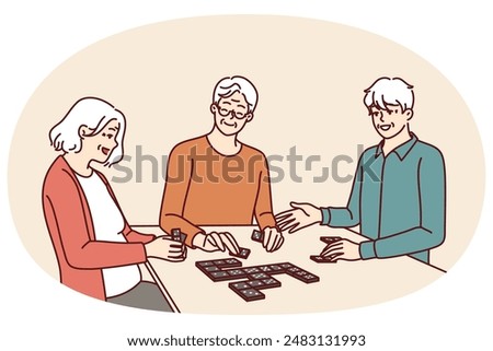 Elderly people play dominoes undergoing rehab at nursing home or having sunday get-together with friends. Men and women are sitting at table enjoying game of dominoes with former colleagues