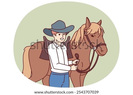 Cowboy boy is standing next to horse caring for stallion and wanting to become professional jockey and race. Schoolboy wearing texas ranger hat near horse for ride or competition at racetrack