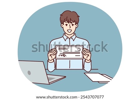 Businessman with paycheck sits at office desk with laptop showing off investments in start-ups from large corporations. Man with paycheck at his workplace demonstrates certificate for large amount