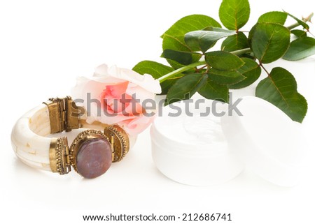 woman hand lotion, vintage bracelet and rose setting