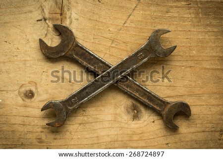 old vintage retro used open-end wrenches on wooden table