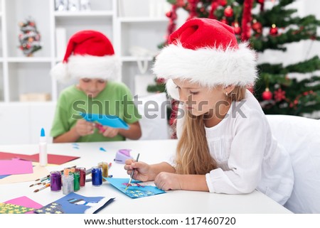 Kids making christmas or seasonal greeting cards