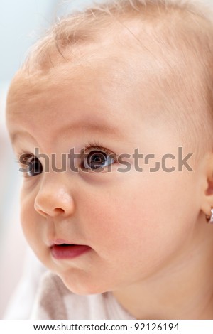 Curious baby girl portrait - extreme closeup