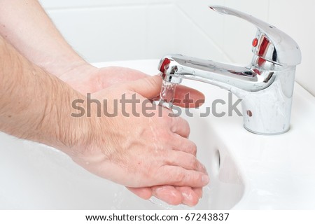 Close-up of human hands being washed
