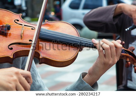 Musician playing violin instrument on the street