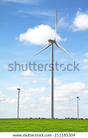 Wind turbine in a green field. Renewable energy source.