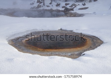 Yellowstone National Park in Winter, Wyoming USA - geothermal mineral pools with snow.