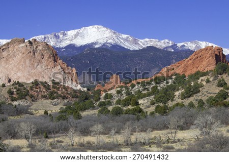 Red rocks at Garden of the Gods in Colorado Springs with Pikes Peak in background.