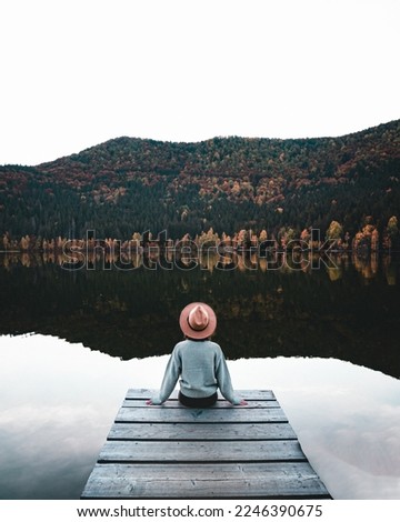 Similar – Image, Stock Photo Lonely woman admiring autumn landscape of lake and mountains