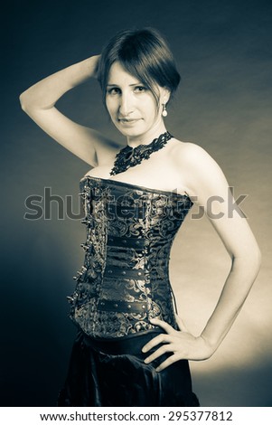Woman playing with her hair isolated on grunge background. Studio shot portrait.