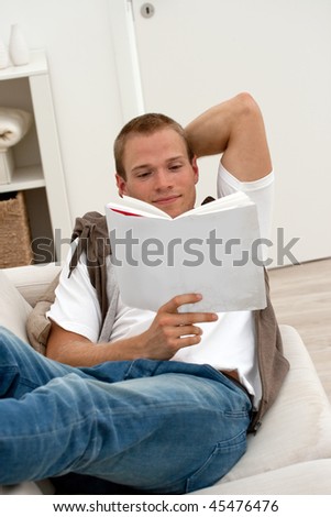 Man relaxing with a book on the couch