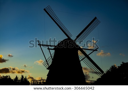 Traditional old windmill. Silhouette at sunset.