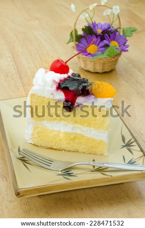 Vanilla cake topping with cherry, orange, Blueberry