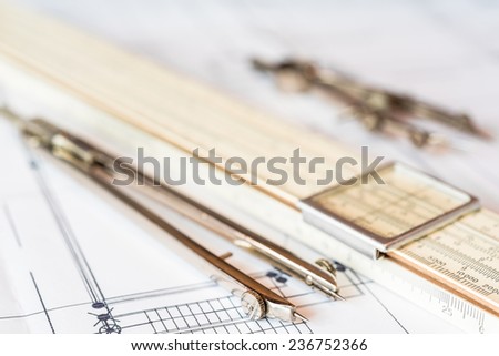 Preparation for drafting papers, the tools and schemes on the table. Angle view
