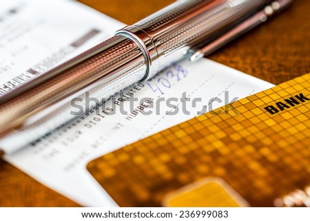 Credit card with a pen and check on the table