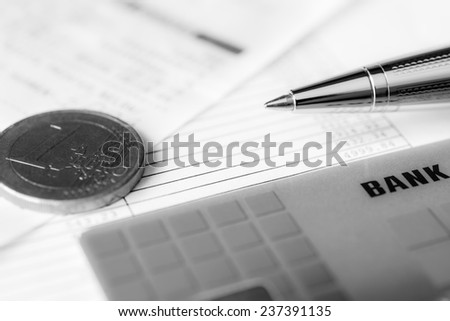 Pay the bills, bank card and pen with check on the table. In soft tone