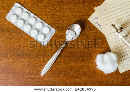 Prescription for the treatment of the disease, a tablets with a syringe on the table. Top view