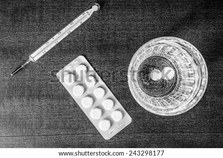 Cure the disease, couple of tablets dissolved at a temperature of the glass of water. Focus on the glass of water, in the black and white tones