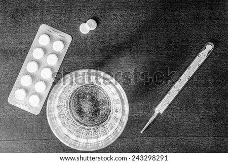 Cure the disease, measure temperature by thermometer and take the pills. In the black and white tones