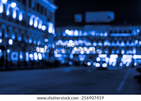 Night city, night life on the streets, the buildings in lights in the background. Image in blue toning
