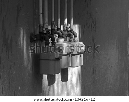 Black and white measuring gas pressure devices and concrete wall background