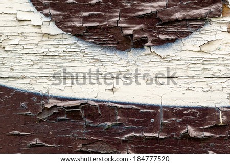 Wooden surface painted in beautiful colors and shapes with partly peeled paint