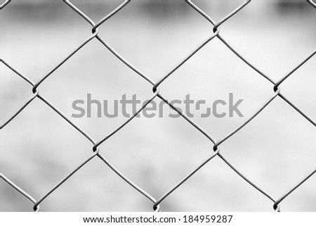 Black and white metallic fence with natural background